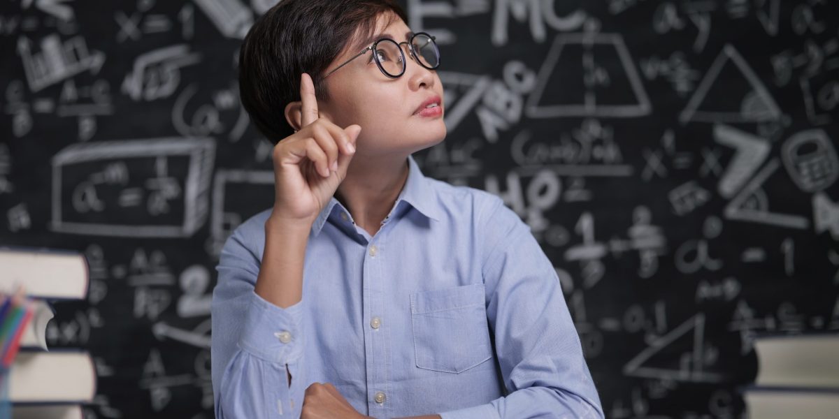 The teacher sat thinking about teaching in the classroom
